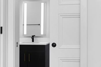 A small bathroom with a sink and a mirror